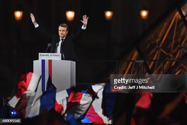 Leader of 'En Marche !' Emmanuel Macron acknowledges supporters after winning the French Presidential Election, at The Louvre on May 7, 2017 in...