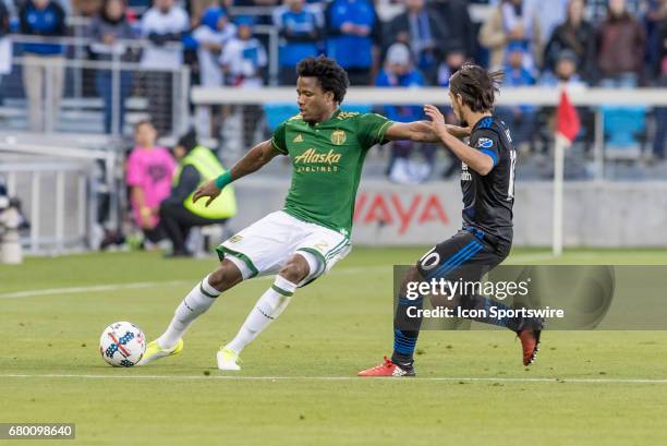 Portland Timbers defender Alvas Powell gives the stiff arm to San Jose Earthquakes midfielder Jahmir Hyka during the Major League Soccer game between...