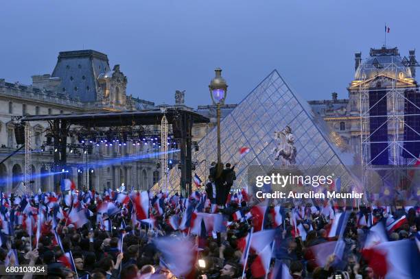 General view as voters are waving flags during Emmanuel Macron speech as he celebrates his Presidential election victory At Le Louvre In Paris on May...