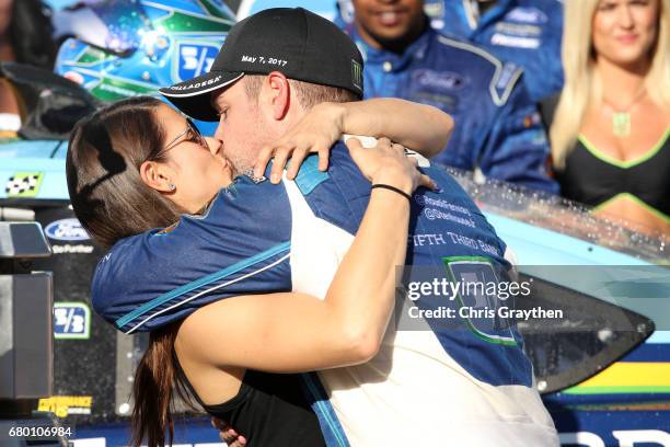 Ricky Stenhouse Jr., driver of the Fifth Third Bank Ford, kisses his girlfriend, Danica Patrick, driver of the Aspen Dental Ford, in Victory Lane...