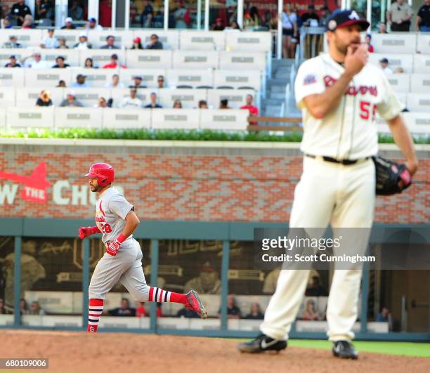 Tommy Pham of the St. Louis Cardinals rounds the bases after hitting a 14th-inning, two-run home run against Josh Collmenter of the Atlanta Braves at...