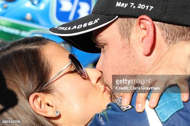 Ricky Stenhouse Jr., driver of the Fifth Third Bank Ford, kisses his girlfriend, Danica Patrick, driver of the Aspen Dental Ford, in Victory Lane...