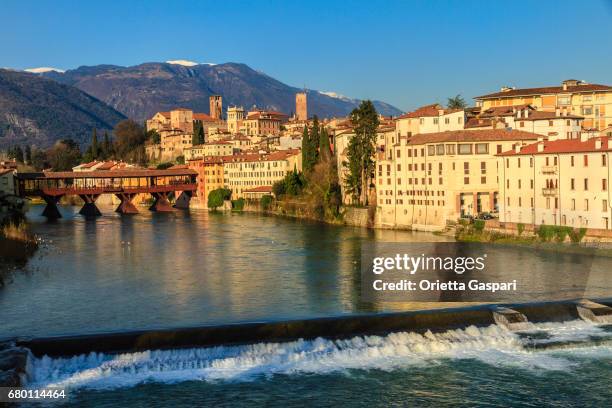 old town of bassano del grappa along the river brenta with the famous ponte degli alpini. province of vicenza, italy - bassano del grappa stock pictures, royalty-free photos & images