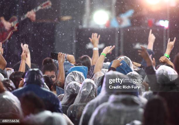 Fans watch the musical band All Time Low perform as rain falls during the concert at the 2017 MTV Movie And TV Awards Festival at The Shrine...