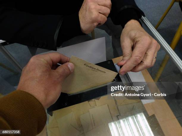 Voters go to the polls in the second round of voting for President, between candidates Marine Le Pen and Emmanuel Macron, on May 7, 2017 in PARIS,...