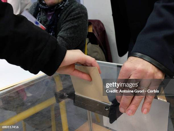 Voters go to the polls in the second round of voting for President, between candidates Marine Le Pen and Emmanuel Macron, on May 7, 2017 in PARIS,...