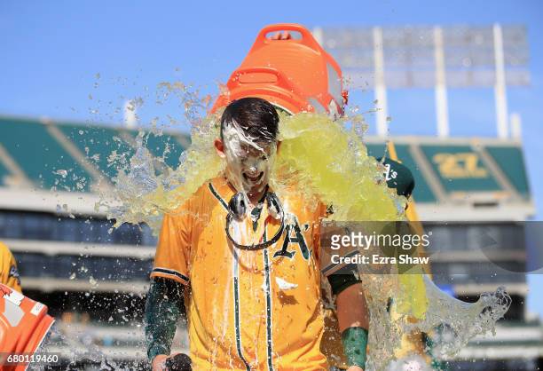 Ryon Healy of the Oakland Athletics is covered in Gatorade after he hit a walk-off home run in the ninth inning against the Detroit Tigers at Oakland...