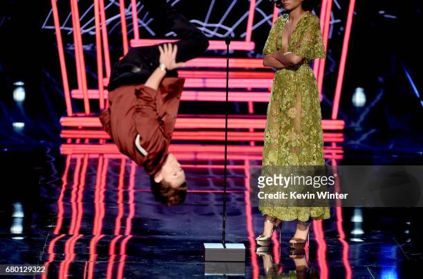 Actor Tom Holland does a backflip as actor Zendaya looks on onstage during the 2017 MTV Movie And TV Awards at The Shrine Auditorium on May 7, 2017...