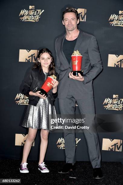 Actors Dafne Keen and Hugh Jackman, winners of the Best Duo award for 'Logan,' attend the 2017 MTV Movie And TV Awards at The Shrine Auditorium on...