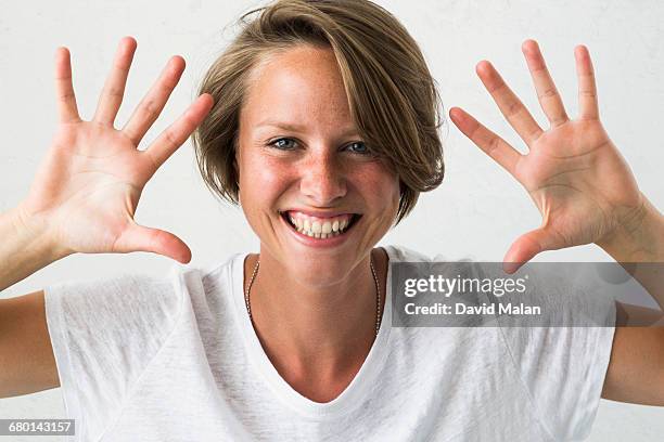 blonde woman showing her hands. - 手のひら ストックフォトと画像