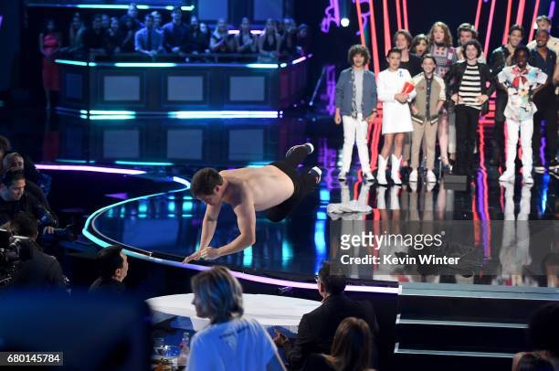 Host Adam DeVine onstage with cast of 'Stranger Things' during the 2017 MTV Movie And TV Awards at The Shrine Auditorium on May 7, 2017 in Los...