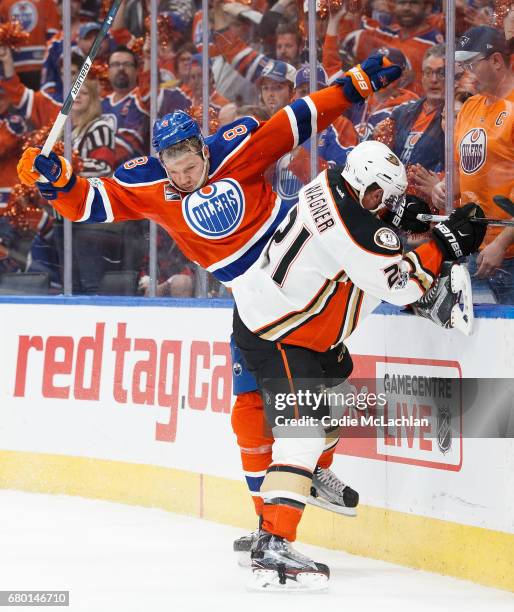 Griffin Reinhart of the Edmonton Oilers hits Chris Wagner of the Anaheim Ducks in Game Six of the Western Conference Second Round during the 2017 NHL...