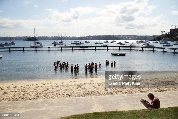 Sydney Swans players cool their legs during a Sydney Swans AFL recovery session at Redleaf Beach on May 8, 2017 in Sydney, Australia.