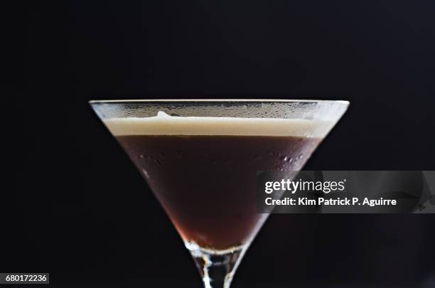 coffee martini on a black background - espresso martini stock pictures, royalty-free photos & images