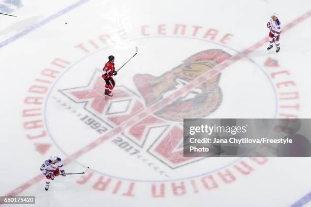 Alexandre Burrows of the Ottawa Senators along with Chris Kreider and Michael Grabner of the New York Rangers skate at centre ice during warmups...