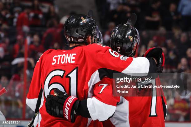 Kyle Turris of the Ottawa Senators celebrates his overtime goal with Mark Stone as he watches the replay against the New York Rangers in Game Five of...