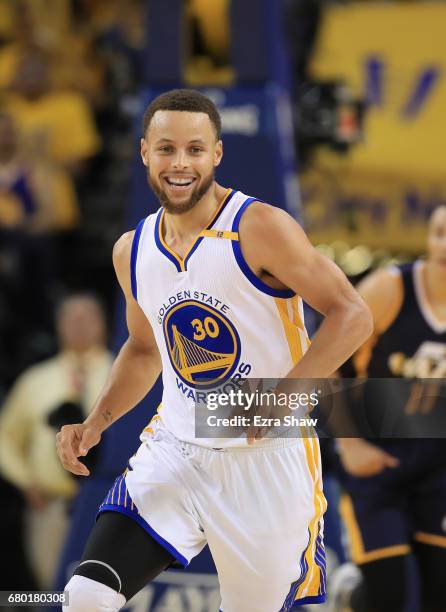 Stephen Curry of the Golden State Warriors smiles after making a basket against the Utah Jazz during Game Two of the Western Conference Semifinals of...