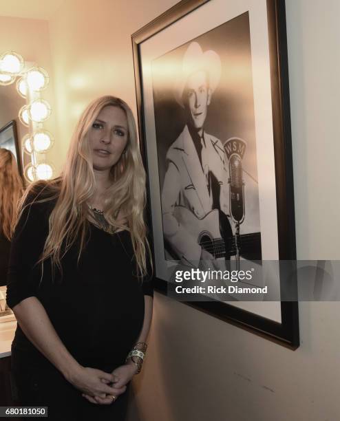 Singer/Songwriter/Grand-Daughter of Hank Williams Sr., Holly Williams pose by Hank Sr. Photograph in the Hank Williams room backstage at The Ryman...
