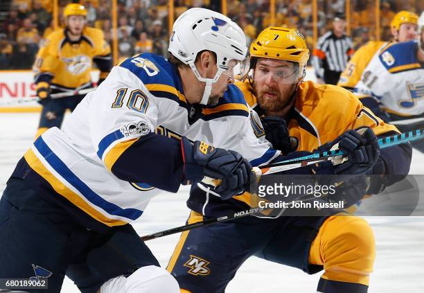 Yannick Weber of the Nashville Predators battles against Scottie Upshall of the St. Louis Blues in Game Four of the Western Conference Second Round...