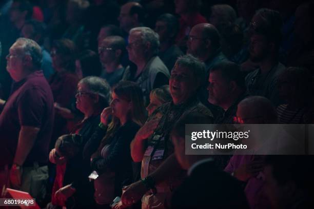 Members of the audience listen as US President Donald Trump addresses the National Rifle Association Leadership Forum in Atlanta, Georgia on April...