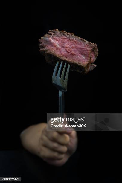 hand use Fork  cut tenderloin beef steak