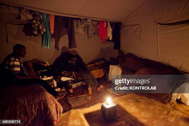 Immigrants take rest in the tent city in San Ferdinando near Rosarno which shelters African seasonal seasonal workers.