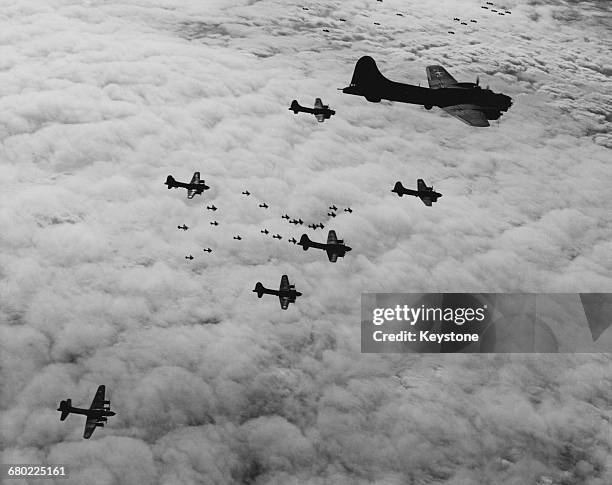 Boeing B-17G Flying Fortress four-engine heavy bombers of the United States Army Air Forces 8th Air Force in flight combat box formation on a bombing...