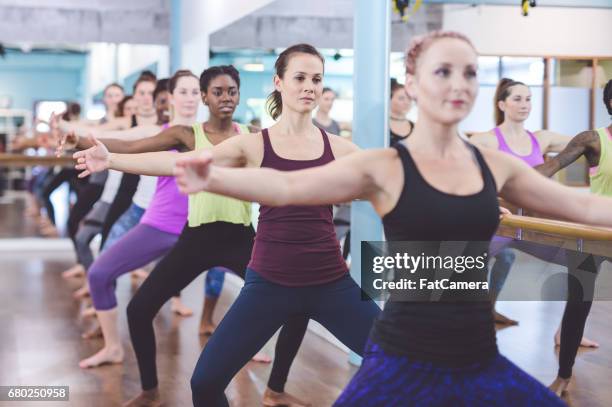 multi-ethnic group of women doing barre workout - pike stretch stock pictures, royalty-free photos & images