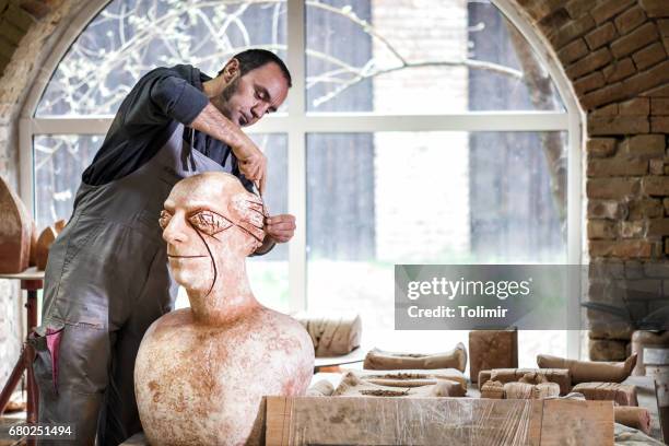 sculptor working on sculpture - sculptor stock pictures, royalty-free photos & images