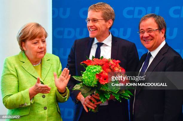 German Chancellor and Christian Democratic Union leader Angela Merkel, CDU candidate in regional elections in Schleswig-Holstein Daniel Guenther and...