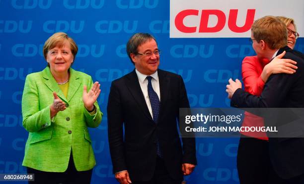 Deputy chairwoman of the CDU Julia Kloeckner embraces CDU candidate in regional elections in Schleswig-Holstein Daniel Guenther as German Chancellor...