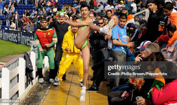 Spectators in fancy dress including one wearing a mankini kick a tennis ball around before the fifth one-day international cricket match between...