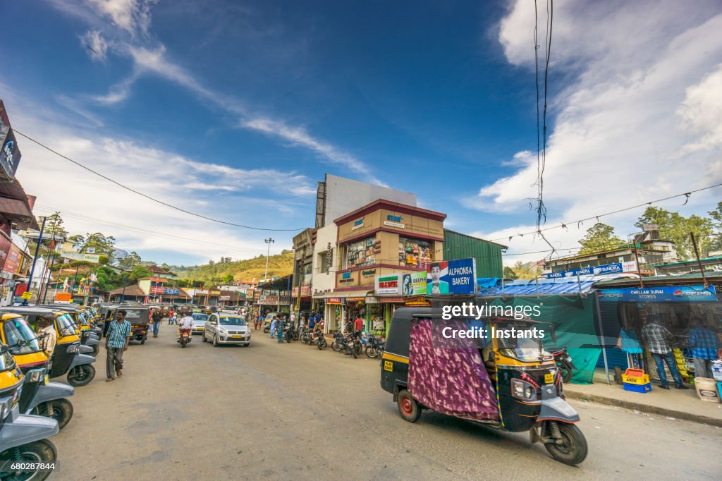 A street scene in the Indian city of Munnar, situated in South India’s Kerala region, where people and buildings are visible in the image.