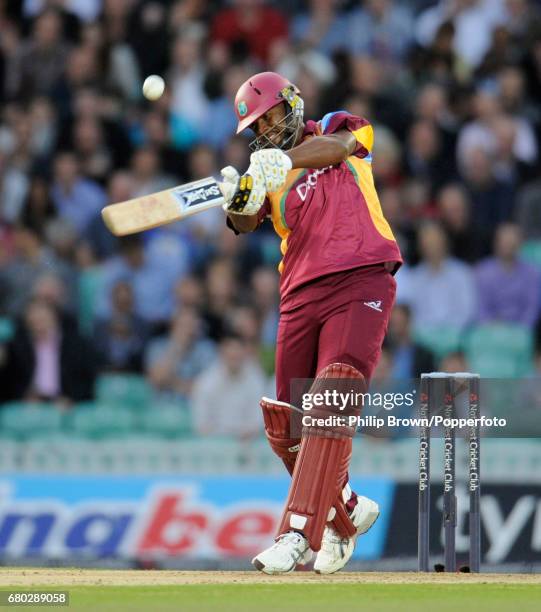 West Indies captain Dwayne Smith hits a six from the bowling of England's Tim Bresnan during the first T20 international cricket match at the Oval...