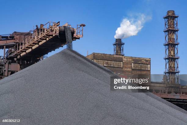 Conveyor belt drops iron ore pellets onto an outdoor storage pile at the Yeristovo and Poltava iron ore mine, operated by Ferrexpo Poltava Mining...