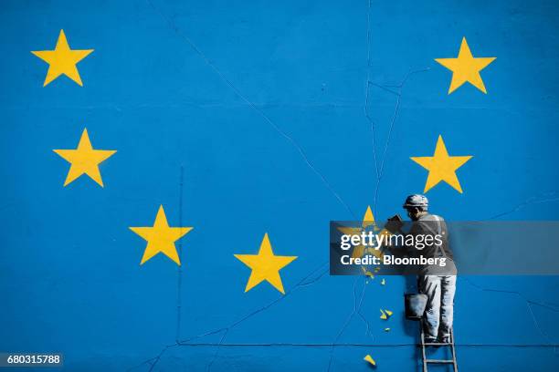 Mural depicting a European Union flag being chiseled by a workman sits on the side of a disused building near the ferry terminal in Dover, U.K., on...