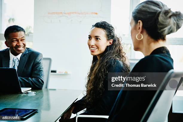 businesswoman leading discussion during meeting - thomas barwick meeting stock pictures, royalty-free photos & images