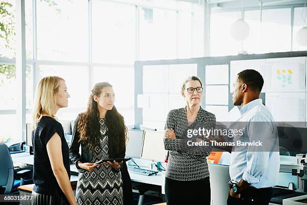 businessman leading informal meeting in office - woman making a deal stock pictures, royalty-free photos & images