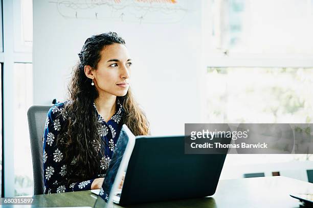 businesswoman working on laptop in office - selective focus foto e immagini stock