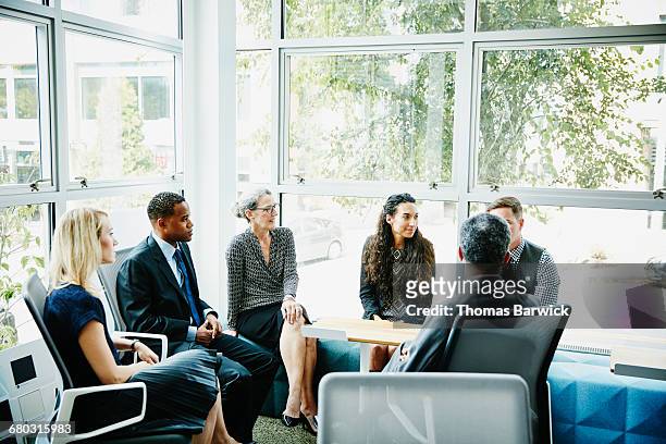 businesspeople in meeting in conference room - leanintogether stock pictures, royalty-free photos & images