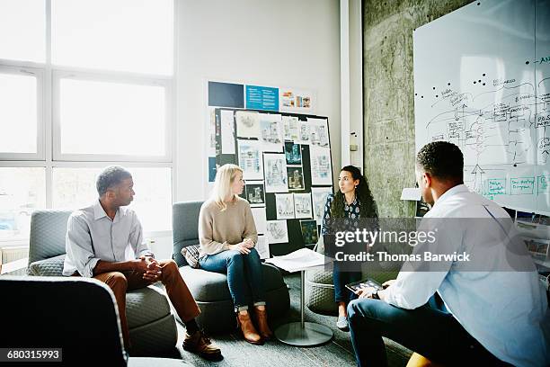 design team having project meeting in office - leanincollection stockfoto's en -beelden