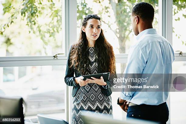 businesswoman in discussion with client in office - leanintogether stock pictures, royalty-free photos & images