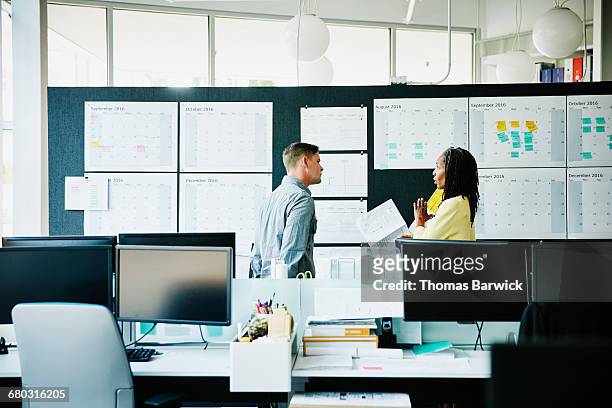 businesswoman leading project timeline discussion - leanintogether stock pictures, royalty-free photos & images