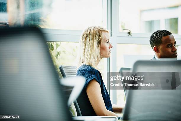 businesswoman listening to presentation - leanintogether stock pictures, royalty-free photos & images