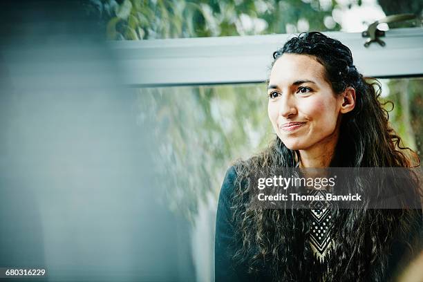 businesswoman in meeting with coworkers in office - one mid adult woman only fotografías e imágenes de stock