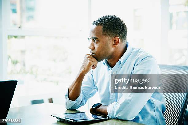 businessman with digital tablet sitting in office - patience office stock pictures, royalty-free photos & images