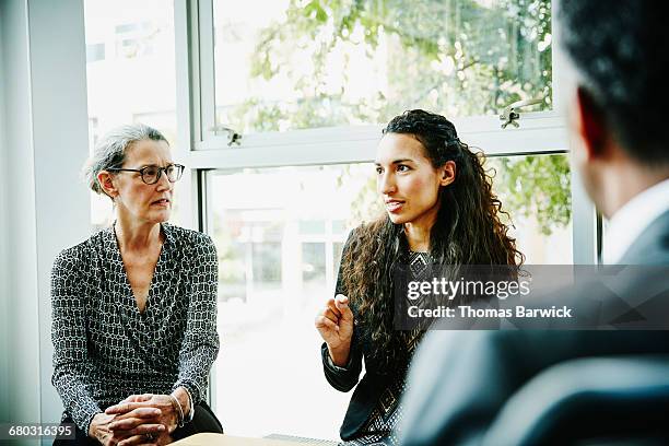 businesswoman leading team meeting in office - selective focus stockfoto's en -beelden