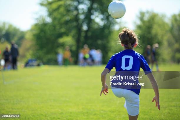 teenage soccer player with soccer field in the background. - american football foto e immagini stock