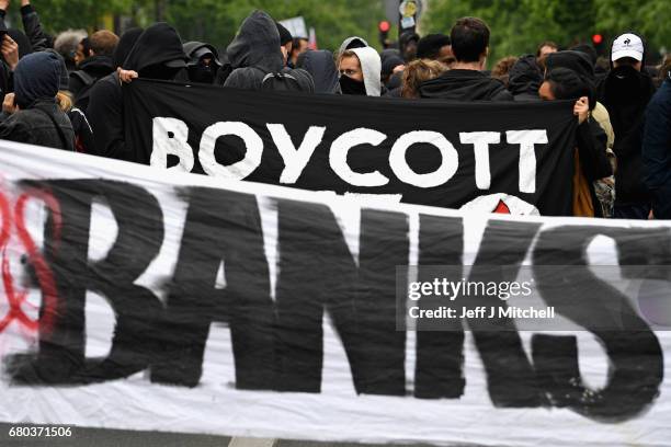 Demonstrators take part in a trade unions demonstrations against the election of Emmanuel Marcon on May 8, 2017 in Paris, France. The centrist...