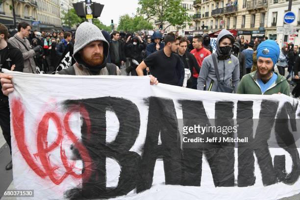 Demonstrators take part in a trade unions demonstrations against the election of Emmanuel Marcon on May 8, 2017 in Paris, France. The centrist...